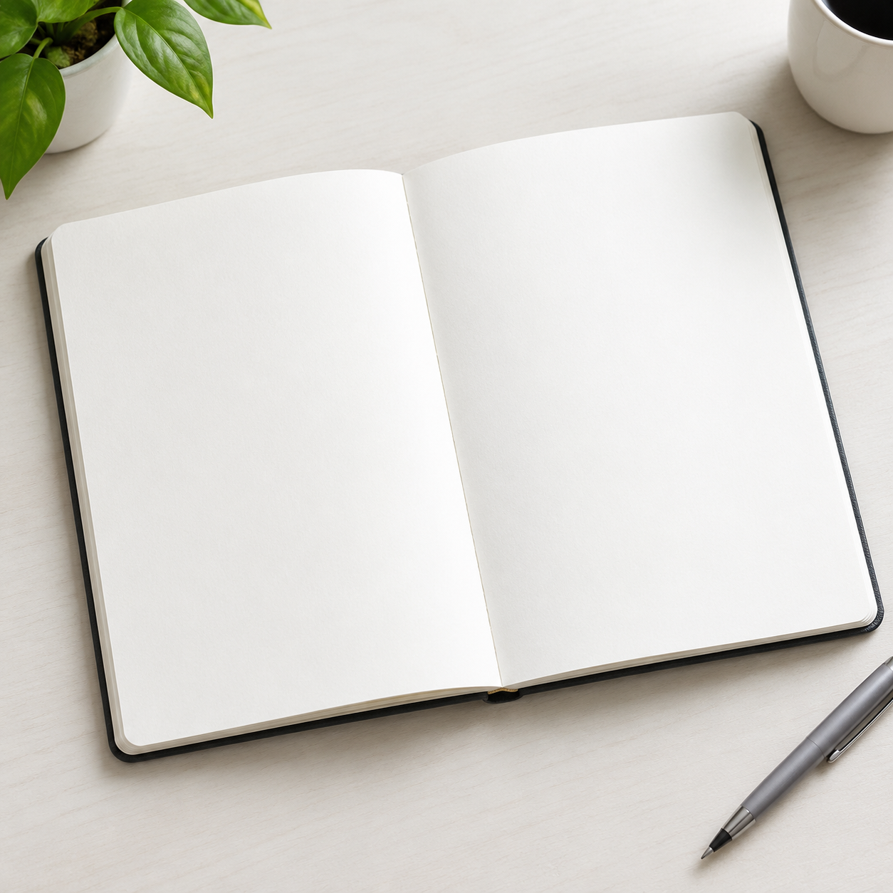 An open blank notebook on a pale desk
